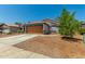 Inviting single-story home featuring a two-car garage and low-maintenance desert landscaping at 14936 W Maui Ln, Surprise, AZ 85379