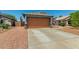 A charming single-story home with a spacious two-car garage and desert landscaping at 14936 W Maui Ln, Surprise, AZ 85379