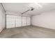 A spacious garage with a concrete floor and a large garage door offers secure parking and storage solutions at 14936 W Maui Ln, Surprise, AZ 85379