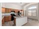 Well-lit kitchen with wood cabinets, an island, and stainless steel appliances at 14936 W Maui Ln, Surprise, AZ 85379
