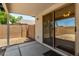 The covered patio with sliding glass doors provides outdoor living and easy access to the backyard at 14936 W Maui Ln, Surprise, AZ 85379