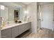 Modern bathroom with double vanity, sleek cabinets, and a glass-enclosed shower at 15215 N Kierland Blvd # 101, Scottsdale, AZ 85254