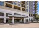 Exterior shot of a modern apartment building entrance with well-maintained landscaping and signage at 15215 N Kierland Blvd # 101, Scottsdale, AZ 85254