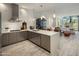 Modern kitchen with white subway tile, stainless steel appliances, and a large island with seating at 15215 N Kierland Blvd # 101, Scottsdale, AZ 85254
