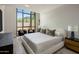 Serene bedroom featuring a large window, comfortable seating, and a plush bed with stylish pillows at 15215 N Kierland Blvd # 101, Scottsdale, AZ 85254