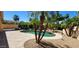 Relaxing backyard oasis with a pool, surrounded by lush landscaping and palm trees at 15728 W Verde Ln, Goodyear, AZ 85395