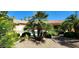 Backyard retreat featuring a swimming pool and a lush garden with diverse plants at 15728 W Verde Ln, Goodyear, AZ 85395