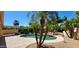 Relaxing backyard oasis with a pool, surrounded by lush landscaping and palm trees at 15728 W Verde Ln, Goodyear, AZ 85395