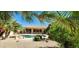 Backyard retreat featuring a swimming pool and a lush garden with diverse plants at 15728 W Verde Ln, Goodyear, AZ 85395