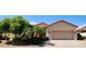 Charming single-story home featuring a two-car garage and meticulously landscaped front yard at 15728 W Verde Ln, Goodyear, AZ 85395