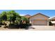 Charming single-story home featuring a two-car garage and meticulously landscaped front yard at 15728 W Verde Ln, Goodyear, AZ 85395