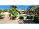 Beautiful backyard pool surrounded by desert landscaping and lush green foliage at 15728 W Verde Ln, Goodyear, AZ 85395