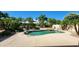 Lush backyard pool with rock waterfall feature and desert landscaping at 15728 W Verde Ln, Goodyear, AZ 85395