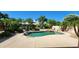 Lush backyard pool with rock waterfall feature and desert landscaping at 15728 W Verde Ln, Goodyear, AZ 85395