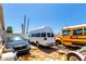 Backyard showing parked vehicles, including a van, car and a yellow school bus at 1602 N 73Rd Dr, Phoenix, AZ 85035