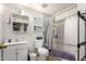 Modest bathroom with a shower-tub combo, a commode, and a single sink vanity with storage at 1602 N 73Rd Dr, Phoenix, AZ 85035