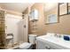 Bathroom featuring a toilet, vanity, a white shower with safety seat and palm-tree patterned shower curtain at 1602 N 73Rd Dr, Phoenix, AZ 85035