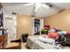 Bedroom with a ceiling fan, a closet with sliding doors, and a view to an attached bathroom at 1602 N 73Rd Dr, Phoenix, AZ 85035