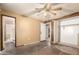 Bedroom featuring a ceiling fan, a closet with sliding doors, and view to an attached bathroom at 1602 N 73Rd Dr, Phoenix, AZ 85035