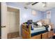 Bedroom with light-blue walls, a ceiling fan, and view to an adjacent room through the doorway at 1602 N 73Rd Dr, Phoenix, AZ 85035