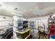 Cluttered garage featuring storage bins and multiple cars at 1602 N 73Rd Dr, Phoenix, AZ 85035