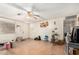 View of a living room with a ceiling fan, outdated laminate floors, and a view of the entry door at 1602 N 73Rd Dr, Phoenix, AZ 85035