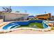 Backyard with an in-ground pool in need of maintenance, surrounded by concrete at 1602 N 73Rd Dr, Phoenix, AZ 85035