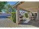 A covered back patio features an outdoor dining set, grill, and low-maintenance gravel landscaping at 16029 W Ocotillo Ln, Surprise, AZ 85374