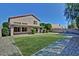 Backyard with gravel borders, grass area, covered patio and block fence at 16029 W Ocotillo Ln, Surprise, AZ 85374