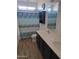 Bathroom showcasing dual sinks, wood-style flooring, patterned shower curtain, and cabinet at 16029 W Ocotillo Ln, Surprise, AZ 85374