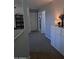 Hallway with carpet, white doors, and decorative accent pieces at 16029 W Ocotillo Ln, Surprise, AZ 85374