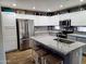 Spacious kitchen with stainless steel refrigerator, island seating, and stylish granite countertops at 16029 W Ocotillo Ln, Surprise, AZ 85374