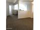 Open living room showcasing neutral carpet and white walls, with loft area at 16029 W Ocotillo Ln, Surprise, AZ 85374