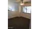 Spacious living room with ceiling fan, neutral carpet and white walls at 16029 W Ocotillo Ln, Surprise, AZ 85374
