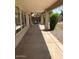 Long covered patio with concrete flooring, view of back yard, and access to home via sliding glass doors at 16029 W Ocotillo Ln, Surprise, AZ 85374