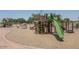 Community playground with climbing structure, slide, and padded ground at 16029 W Ocotillo Ln, Surprise, AZ 85374