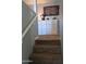 Carpeted staircase with white cabinets and decorative items on the landing at 16029 W Ocotillo Ln, Surprise, AZ 85374