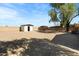 Large, gravel backyard with a shed and mature trees at 16523 N Queen Esther Dr, Surprise, AZ 85378