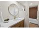 Bathroom showcasing a modern vanity with a round mirror and stylish shower at 16523 N Queen Esther Dr, Surprise, AZ 85378