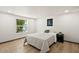 Bright bedroom with hardwood floors and a large window at 16523 N Queen Esther Dr, Surprise, AZ 85378