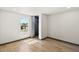 A well-lit bedroom with hardwood floors and a large window at 16523 N Queen Esther Dr, Surprise, AZ 85378