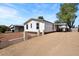 Home with a gravel driveway and mature trees at 16523 N Queen Esther Dr, Surprise, AZ 85378
