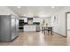 Modern kitchen with stainless steel appliances, white cabinetry, and an adjacent dining area at 16523 N Queen Esther Dr, Surprise, AZ 85378