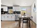 Contemporary kitchen showcasing white cabinetry, stainless steel appliances, and an adjacent dining table at 16523 N Queen Esther Dr, Surprise, AZ 85378