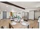 Open concept living and dining area with stainless steel refrigerator and hardwood flooring at 16523 N Queen Esther Dr, Surprise, AZ 85378