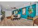 Bright dining area features wood floors, ceiling fan, and unique turquoise accent wall at 18035 N 29Th Dr, Phoenix, AZ 85053