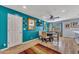 Dining area with wood floors, turquoise wall, ceiling fan, table, and chairs at 18035 N 29Th Dr, Phoenix, AZ 85053