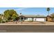 Charming single-story home with white brick, desert landscaping, and a two-car garage under a clear blue sky at 18035 N 29Th Dr, Phoenix, AZ 85053