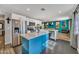Modern kitchen with white cabinetry, a blue island, stainless steel appliances, and decorative backsplash at 18035 N 29Th Dr, Phoenix, AZ 85053