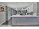 Spacious kitchen with white cabinets, stainless steel appliances, and an island, flowing into the adjacent living spaces at 18035 N 29Th Dr, Phoenix, AZ 85053